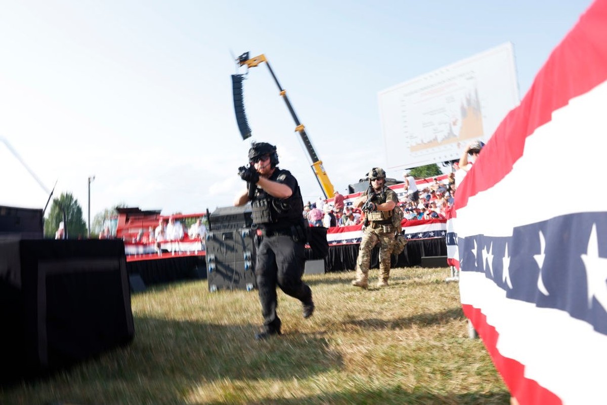 BUTLER, PENNSYLVANIA - JULY 13: Law enforcement officers move during a rally on July 13, 2024 in Butler, Pennsylvania. Butler County district attorney Richard Goldinger said the shooter is dead after  ...