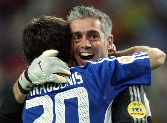 Greek goalkeeper Antonios Nikopolidis hugs teammate Georgios Karagounis at the end of the Euro 2004 semi final soccer match between Greece and the Czech Republic at the Dragao stadium in Porto, Portug ...