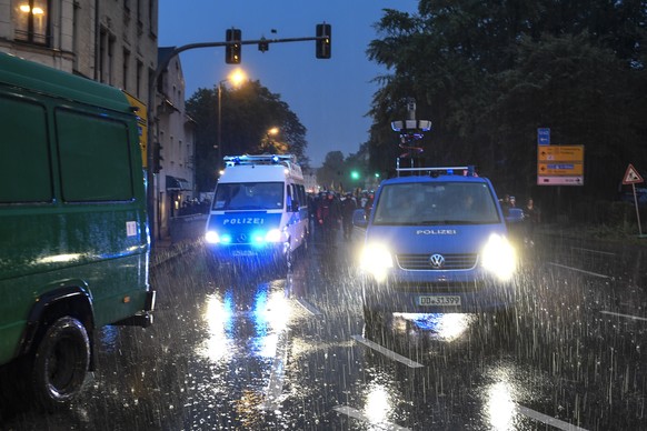 epa07003785 Police gather in the rain in central Chemnitz, Germany, 07 September 2018, to cover announced demonstrations of the right-wing populist movement &#039;Pro Chemnitz&#039; and a counter prot ...