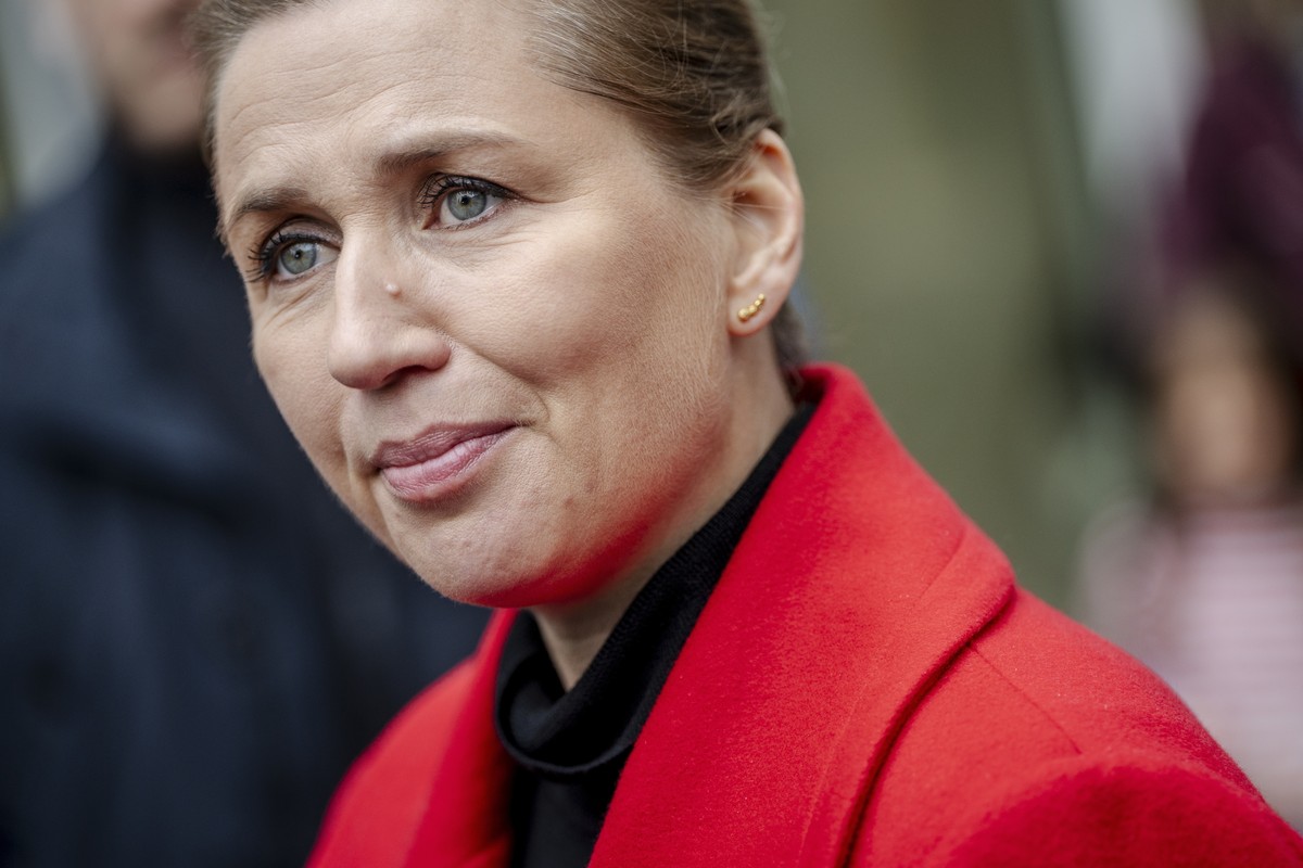 epa12481309 Denmarks Prime Minister and chair of the Social Democratic Party, Mette Frederiksen, speaks with locals while hanging election posters for the municipal and regional elections 2025 in Her ...