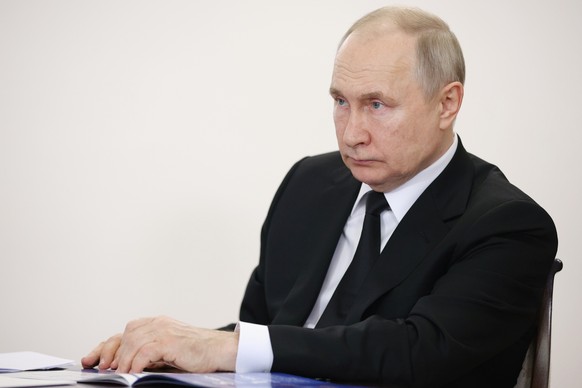 Russian President Vladimir Putin listens to the head of Bashkortostan Radiy Khabirov during their meeting in Ufa, the capital of Bashkortostan, Russia, Friday, January 13, 2023. (Sergei Bobylev, Sputnik, Kre...