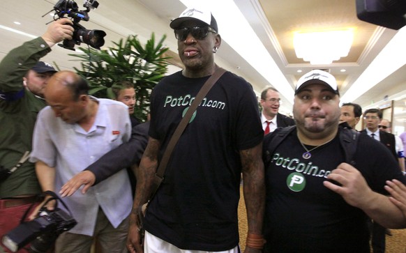 Former NBA basketball star Dennis Rodman, center, arrives at Sunan International Airport on Tuesday, June 13, 2017, in Pyongyang, North Korea. Rodman has arrived in North Korea on his first visit sinc ...