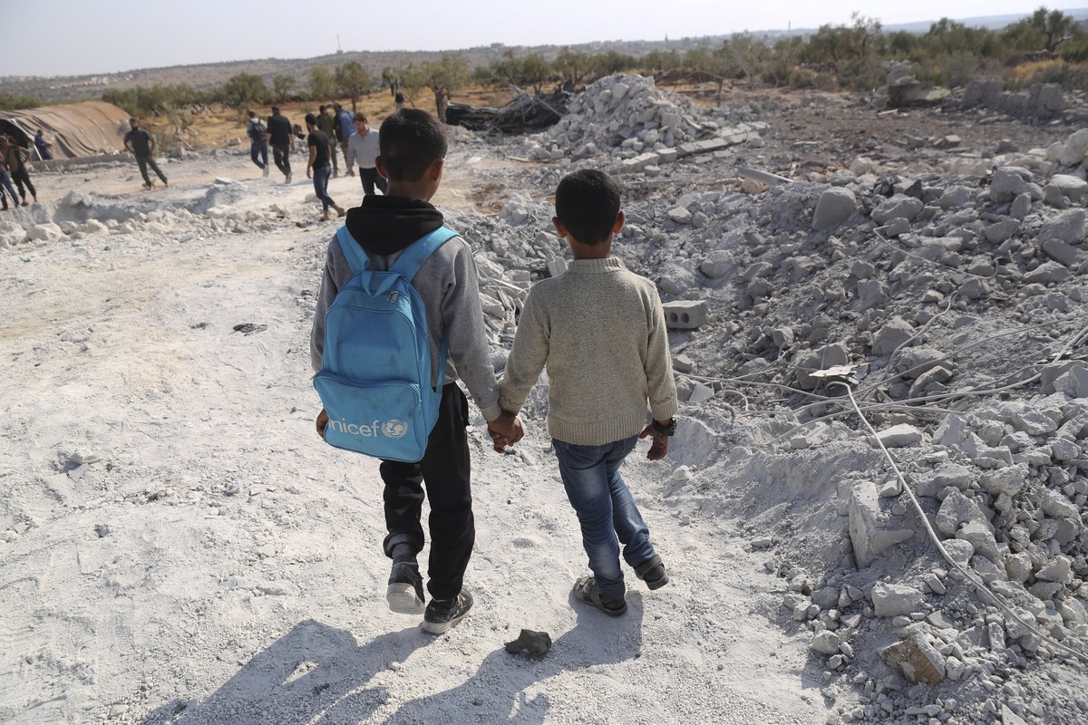 People look at a destroyed houses near the village of Barisha, in Idlib province, Syria, Sunday, Oct. 27, 2019, after an operation by the U.S. military which targeted Abu Bakr al-Baghdadi, the shadowy ...