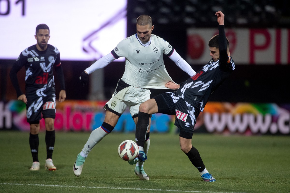 Lugano's player Albian Hajdari, right, fights for the ball with Basel's Djordje Jovanovic, left, during the Super League soccer match FC Lugano against FC Basel, at the Cornaredo Stadium in  ...