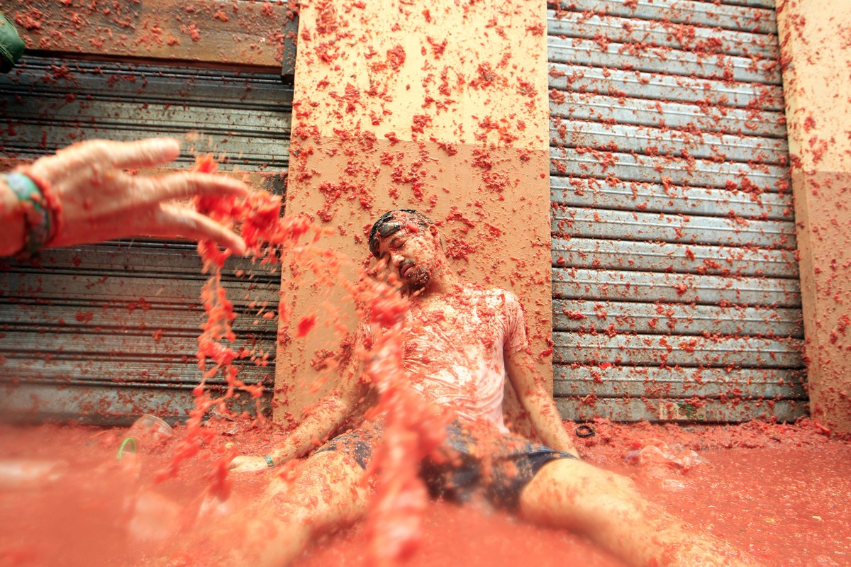 Revelers enjoy as they throw tomatoes at each other, during the annual "Tomatina", tomato fight fiesta, in the village of Bunol, 50 kilometers outside Valencia, Spain, Wednesday, Aug. 30, 20 ...