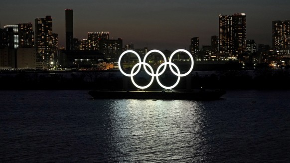 epa08651921 (FILE) - A giant Olympic rings monument is seen at dusk at Odaiba Marine Park in Tokyo, Japan, 25 March 2020 (reissued 07 September 2020). John Coates, Vice-president of the International  ...