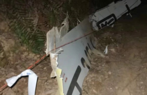 epa09841567 A view of debris from a China Eastern Airlines that crashed into a mountainside in Tengxian County, Guangxi region, southern China, 21 March 2022 (issued 22 March 2022). A China Eastern Ai ...
