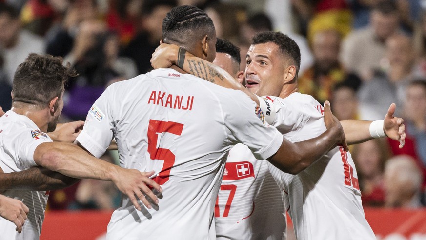 Switzerland&#039;s defender Manuel Akanji, 2nd left, celebrates with Granit Xhaka, right, after scoring to 0:1, during the UEFA Nations League group A2 soccer match between Spain and Switzerland at th ...