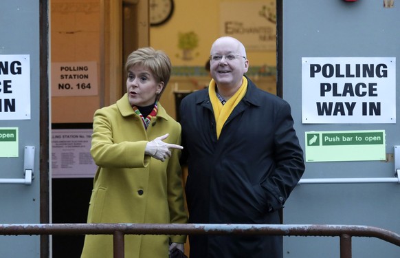 FILE - Scottish First Minister Nicola Sturgeon poses for the media with husband Peter Murrell, outside polling station in Glasgow, Scotland, on Dec. 12, 2019. The husband of former Scottish First Mini ...