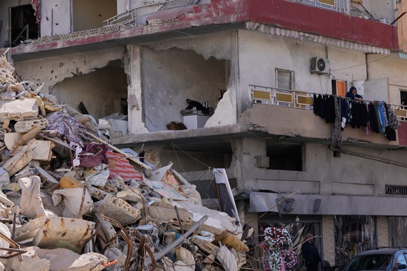 A woman hangs laundry in her damaged apartment after returning home with her family in the southern port city of Tyre, Lebanon, Thursday, April 30, 2026. (AP Photo/Hussein Malla)
Lebanon Israel Iran W ...