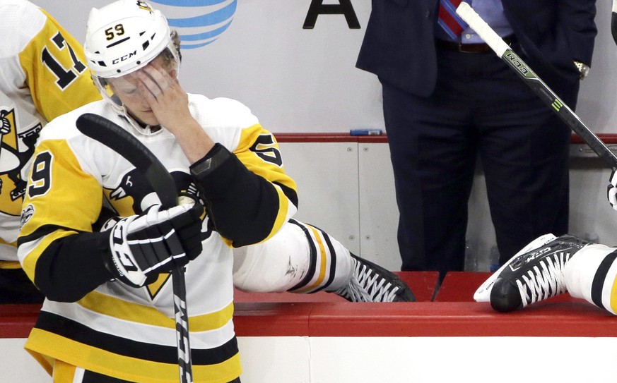 Pittsburgh Penguins coach Mike Sullivan, right, and center Jake Guentzel react after Chicago Blackhawks left wing Brandon Saad scored his third goal of the night,p during the third period of an NHL ho ...