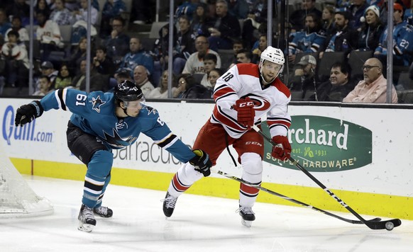 Carolina Hurricanes&#039; Jay McClement (18) is defended by San Jose Sharks&#039; Justin Braun (61) during the second period of an NHL hockey game Saturday, Dec. 10, 2016, in San Jose, Calif. (AP Phot ...