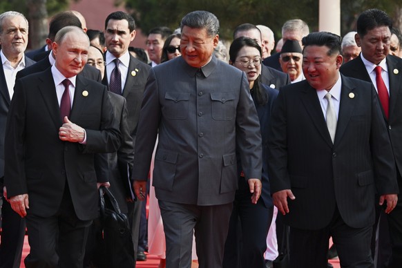 Front from left, Russian President Vladimir Putin, Chinese President Xi Jinping and North Korean leader Kim Jong Un arrive at a military parade to commemorate the 80th anniversary of Japan's Worl ...