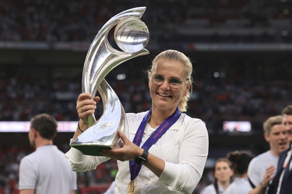 England's manager Sarina Wiegman poses with the trophy after the Women's Euro 2022 final soccer match between England and Germany at Wembley stadium in London, Sunday, July 31, 2022. (AP Pho ...