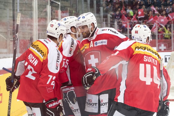 SwitzerlandÕs Denis Malgin, SwitzerlandÕs Romain Loeffel, SwitzerlandÕs Philippe Furrer and SwitzerlandÕs Pius Suter, from left, react after the first goal (1-0) during a friendly ice hockey game betw ...