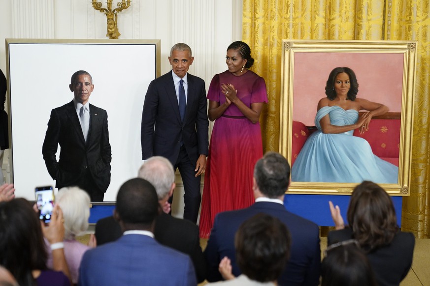 Former President Barack Obama and former first lady Michelle Obama react after unveiling their official White House portraits during a ceremony in the East Room of the White House, Wednesday, Sept. 7, ...