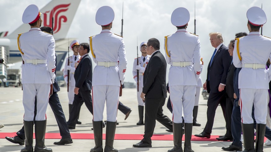 Members of a Vietnamese honor guard stand as U.S. President Donald Trump arrives at Danang International Airport, Friday, Nov. 10, 2017, in Danang, Vietnam. Trump is on a five-country trip through Asi ...