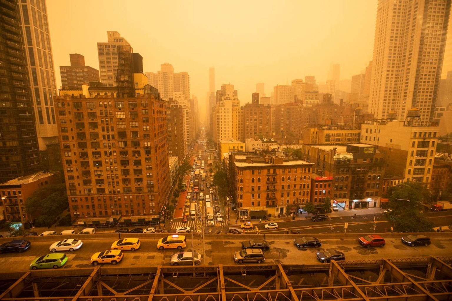 NEW YORK, NEW YORK - JUNE 7: Traffic moves over the Ed Koch Queensboro Bridge as smoke from Canadian wildfires casts a haze over the area on June 7, 2023 in New York City. Air pollution alerts were is ...