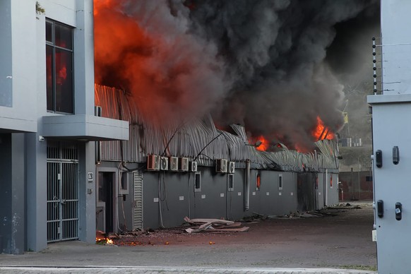 A factory burns on the outskirts of Durban, South Africa, Wednesday, July 14, 2021 in ongoing unrest. Rioting has continued which was sparked by the imprisonment last week of ex-President Jacob Zuma r ...