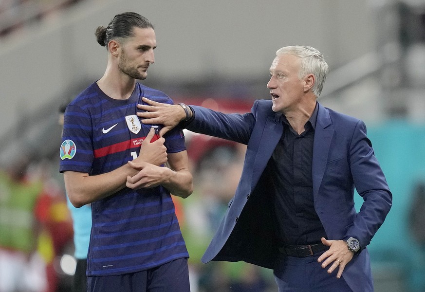France&#039;s manager Didier Deschamps, right, pushes France&#039;s Adrien Rabiot during the Euro 2020 soccer championship round of 16 match between France and Switzerland at the National Arena stadiu ...