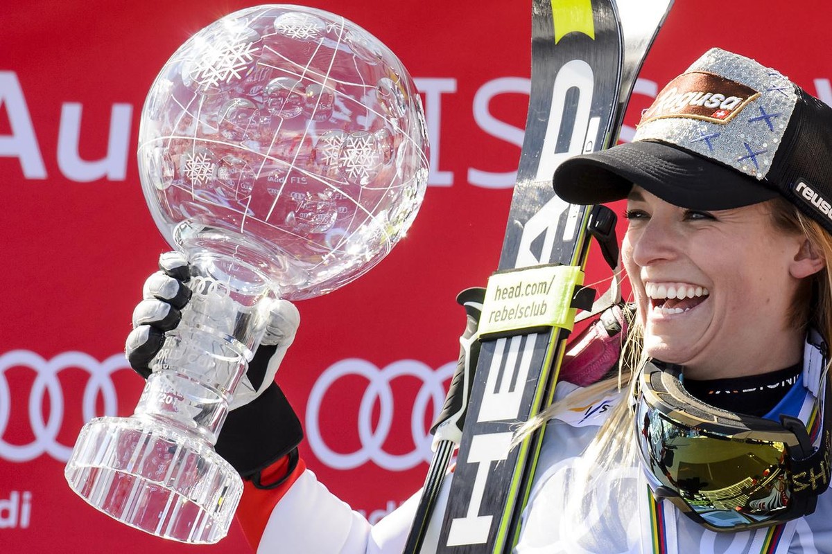 Lara Gut of Switerland celebrates with the women's Alpine Skiing World Cup Overall trophy during the podium ceremony at the FIS Alpine Ski World Cup Finals, in St. Moritz, Switzerland, Sunday, Ma ...