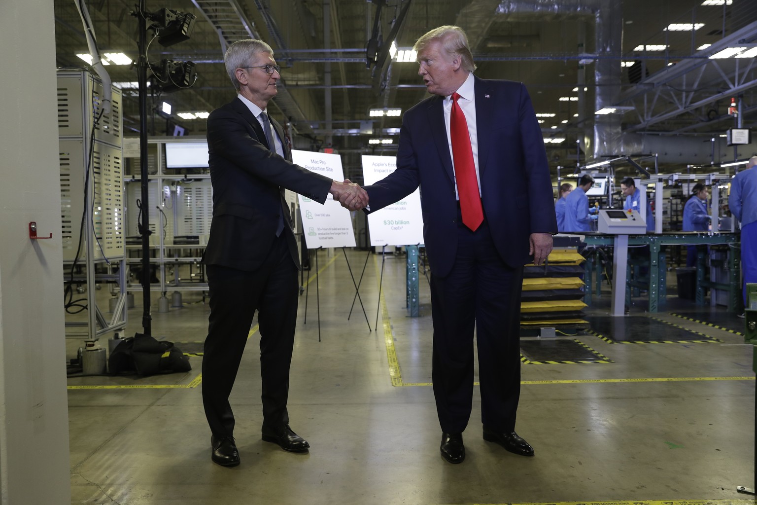Apple CEO Tim Cook and President Donald Trump shake hands during a tour of an Apple manufacturing plant, Wednesday, Nov. 20, 2019, in Austin. (AP Photo/ Evan Vucci)
Donald Trump