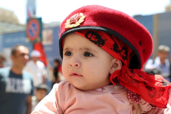 A child attends a march organised by Lebanese Communist party to mark Labour Day in Beirut May 1, 2015. International Workers&#039; Day, also known as Labour Day or May Day, commemorates the struggle  ...