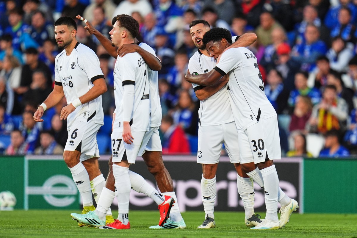 Lugano's Albian Ajeti, second right, is congratulated by teammates after scoring their third goal during the Conference League opening phase soccer match between Getafe and Lugano in Getafe, Spai ...