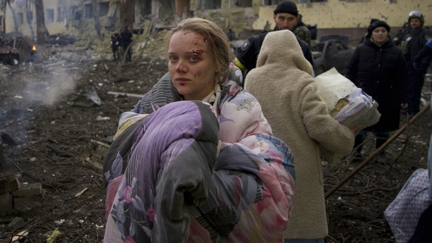 FILE - Marianna Vishegirskaya stands outside a maternity hospital that was damaged by shelling in Mariupol, Ukraine, March 9, 2022. Vishegirskaya survived the shelling and later gave birth to a girl i ...