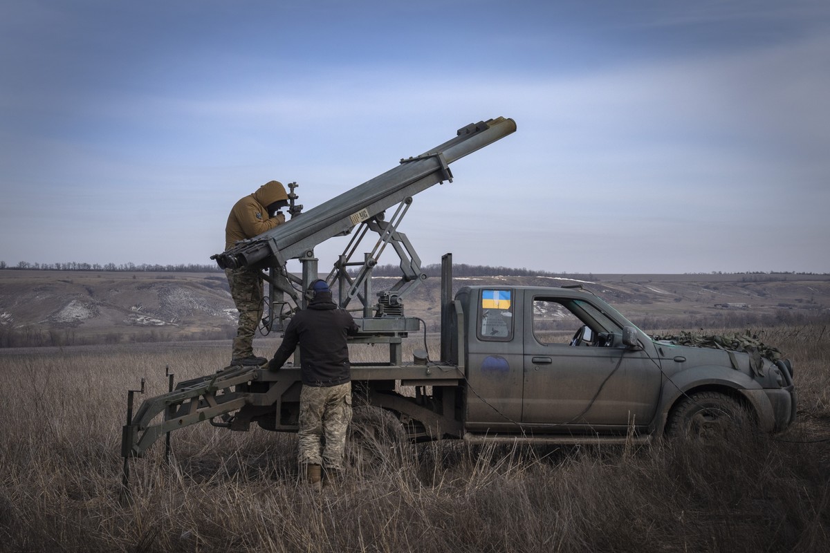 FILE - Ukrainian soldiers from The 56th Separate Motorized Infantry Mariupol Brigade prepare to fire a multiple launch rocket system based on a pickup truck towards Russian positions at the front line ...