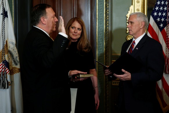 U.S. Vice President Mike Pence (R) swears in Mike Pompeo, flanked by his wife Susan Pompeo, to be director of the Central Intelligence Agency in the vice president&#039;s ceremonial office in the Eise ...