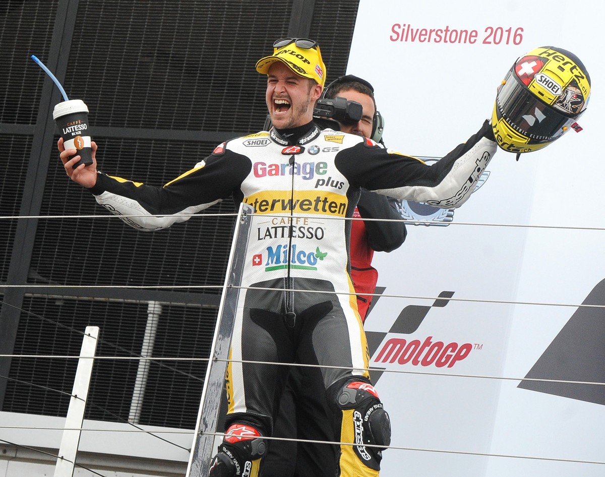Switzerland's Thomas Luthi of Garage Plus Interwetten celebrates on the podium after winning the Moto2 race at the British Grand Prix at Silverstone, England, Sunday, Sept. 4, 2016. (AP Photo/Rui ...