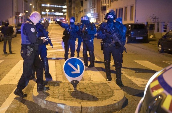 Hooded police officers block the access in Strasbourg, eastern France, Thursday Dec. 13, 2018. A top French official says a man has been killed in a shootout with police in Strasbourg, but he has not been confirmed as the suspected gunman who killed three people near a Christmas market. (AP Photo/Jean-Francois Badias)