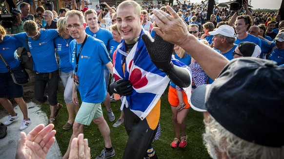 epa07671570 Dutch Former World Champion Maarten van der Weijden (C) at the finish in Leeuwarden after his second attempt to swim the Elfstedentocht, The Netherlands, 24 June 2019. In August 2018 the s ...