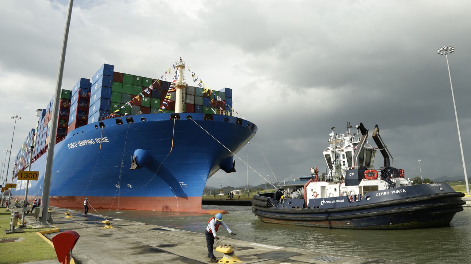 FILE - A Panama Canal worker docks the Chinese container ship Cosco at the Panama Canals&#039; Cocoli Locks, in Panama City on Dec. 3, 2018. China&#039;s Belt and Road initiative has built power plant ...