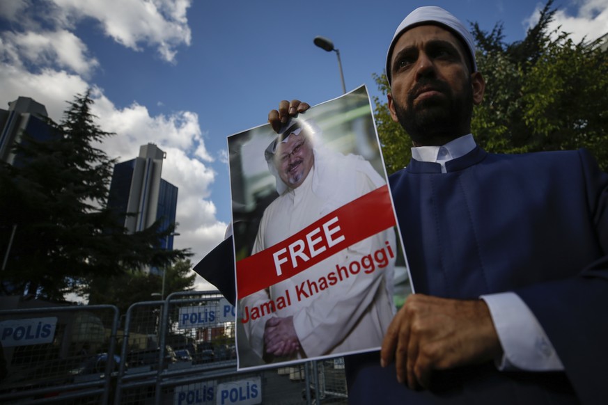 Holding a poster of missing Saudi writer Jamal Khashoggi, a man stands near the Saudi Arabia consulate in Istanbul, Friday, Oct. 5, 2018. Khashoggi, a 59-year-old veteran journalist who has lived in s ...