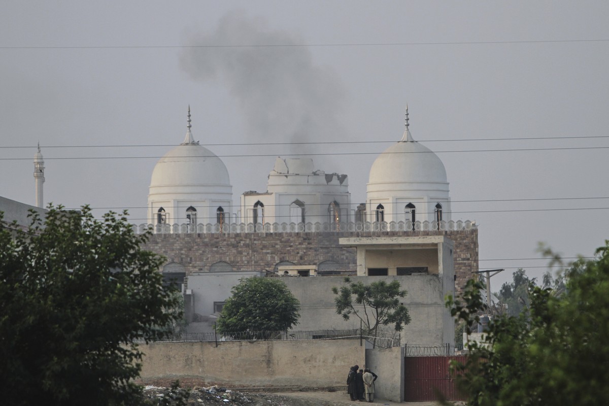 Local residents stand outside a mosque of an Islamic seminary partially damaged by a suspected Indian missile attack, outskirts of Bahawalpur, Pakistan, Wednesday, May 7, 2025. (AP Photo/Asim Tanveer) ...