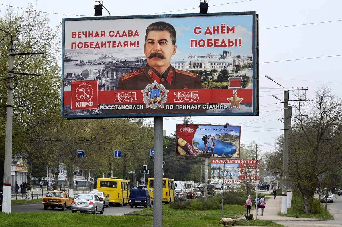 A billboard reading "Eternal glory to the victors" sponsored by the Communist Party, which has always praised Stalin's role in the defeat of Nazi Germany is seen in a street in Sevastop ...