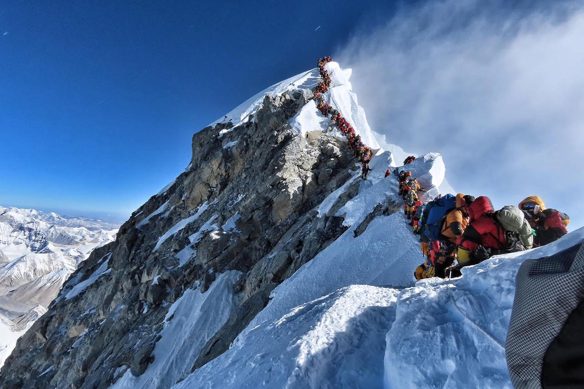 (FILES) In this file handout photo taken on May 22, 2019 and released by climber Nirmal Purja's Project Possible expedition shows heavy traffic of mountain climbers lining up to stand at the summ ...