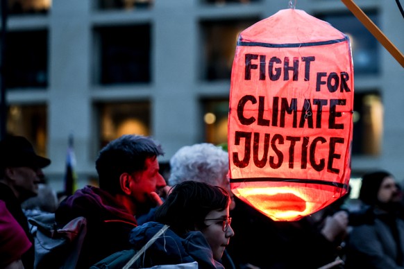 epa12526442 People attend a Fridays for Future demonstration 'Global climate strike during the World Climate Conference' in front of Brandenburg gate in Berlin, Germany, 14 November 2025. EP ...