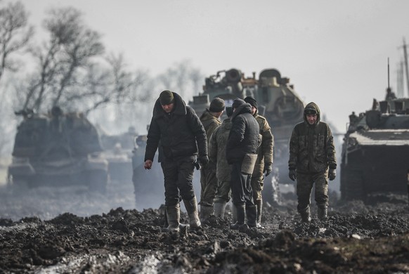 epa09776749 Russian servicemen and armoured vehicles stand on the road in Rostov region, Russia, 22 February 2022. On February 21, Russian President Vladimir Putin convened an extraordinary large meet ...