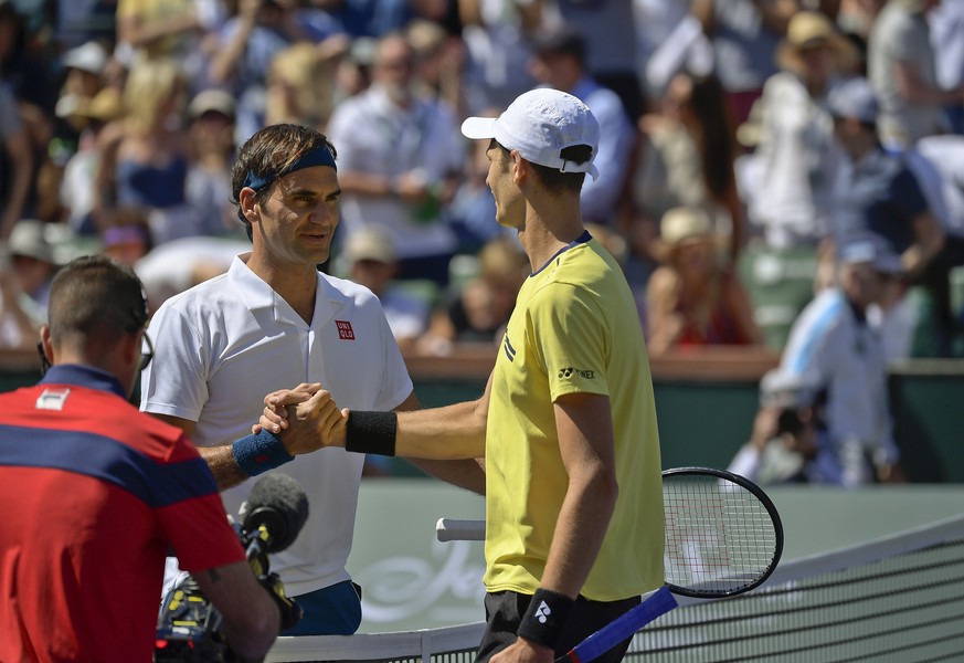 Roger Federer, of Switzerland, left, shakes hands with Hubert Hurkacz, of Poland at the BNP Paribas Open tennis tournament Friday, March 15, 2019, in Indian Wells, Calif. Federer defeated Hurkacz, 6-4 ...