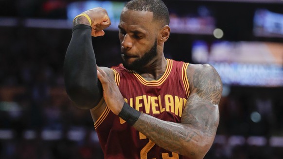 FLE - In this March 19, 2017, file photo, Cleveland Cavaliers&#039; LeBron James flexes his arm after making a basket and drawing a foul call against the Los Angeles Lakers during the second half of a ...
