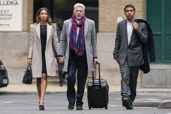 Former tennis player Boris Becker, center, walks with his partner Lilian de Carvalho Monteiro, left and son Noah as they arrive at Southwark Crown Court, in London, Friday, April 8, 2022. Becker is on ...