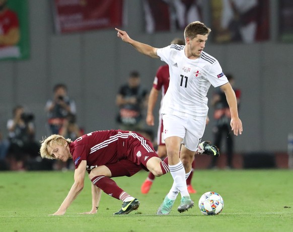 epa07008250 Georgia&#039;s Giorgi Chakvetadze (R) in action against Latvia&#039;s Ivans Lukjanovs (L) during the UEFA Nations league, league D group 1 soccer match between Georgia and Latvia at the Bo ...