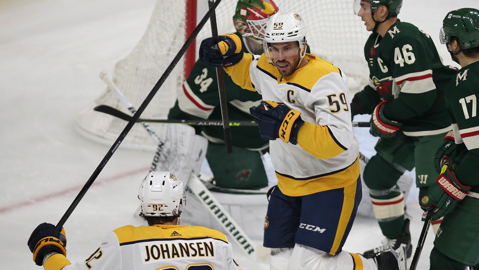 Nashville Predators defenseman Roman Josi (59) celebrates his goal with Predators center Ryan Johansen (92) as Minnesota Wild goaltender Kaapo Kahkonen (34) and Wild defenseman Jared Spurgeon (46) loo ...