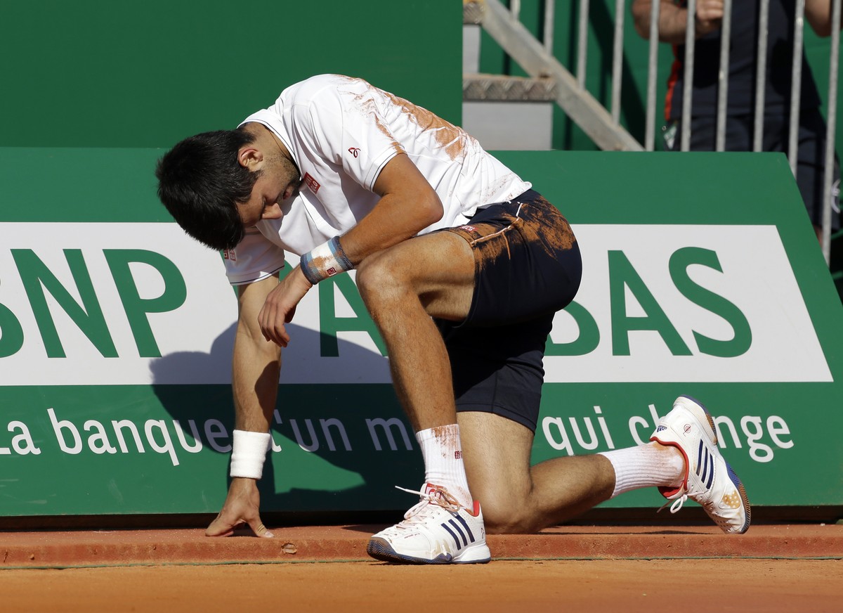 Serbia's Novak Djokovic falls, during their quarterfinal match of the Monte Carlo Tennis Masters tournament against Belgium's David Goffin, in Monaco, Friday, April, 21, 2017. (AP Photo/Clau ...