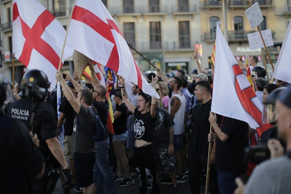 Far-right protesters shout slogans after a van attack in Barcelona, Spain, Friday Aug. 18, 2017. Police on Friday shot and killed five people carrying bomb belts who were connected to the Barcelona va ...