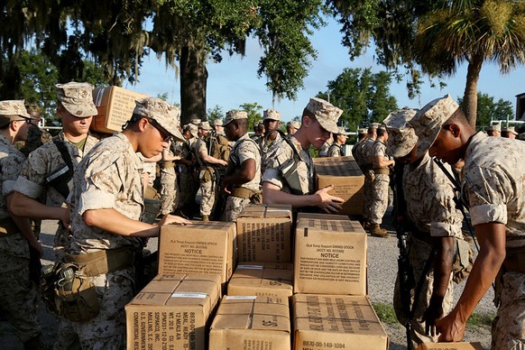 In this photo released by the U.S. Marine Corps, recruits at Marine Corps Recruit Depot Parris Island, S.C., prepare to evacuate to Marine Corps Logistic Base Albany following an evacuation order dire ...
