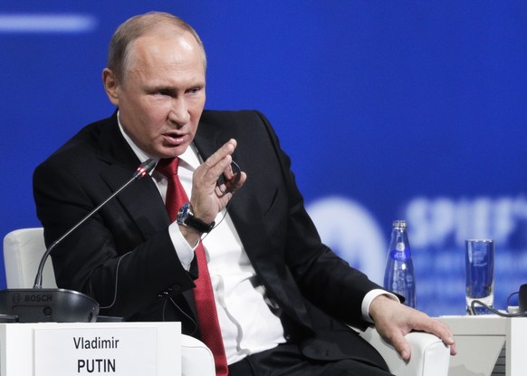 Russian President Vladimir Putin answers a question at the St. Petersburg International Economic Forum in St.Petersburg, Russia, Friday, June 2, 2017. Putin has ridiculed the U.S. focus on Russian amb ...